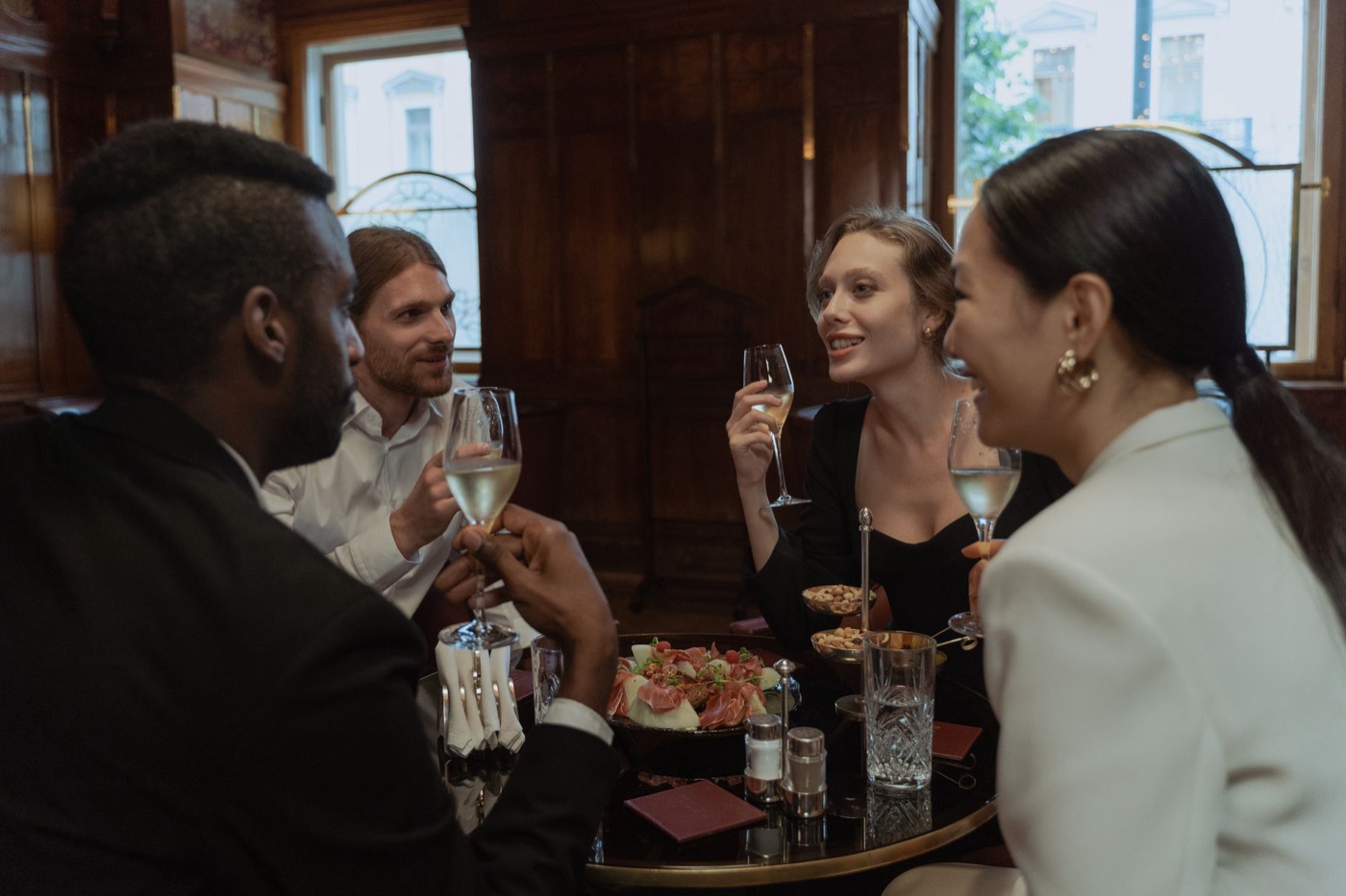 Four people with drinks at a restaurant table